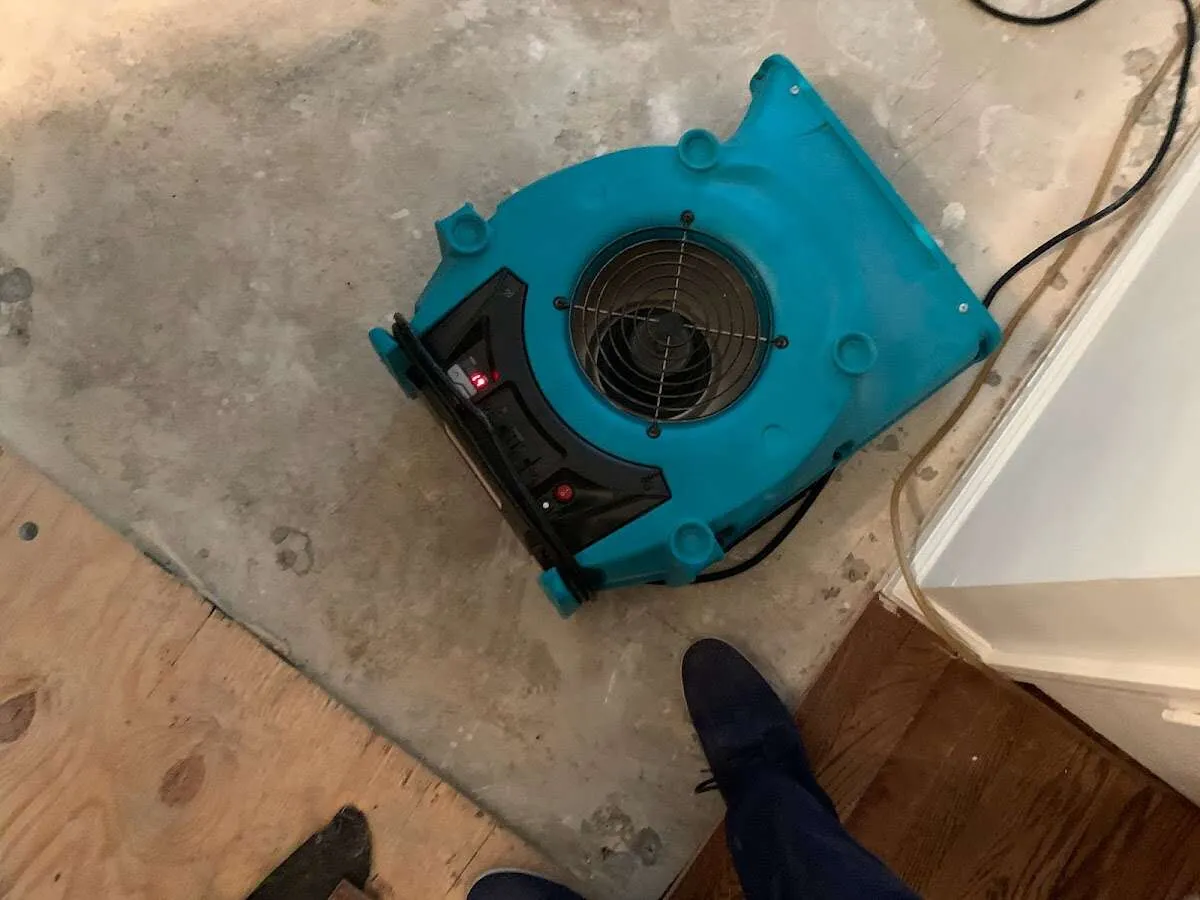 Air mover drying subfloor during Commercial Water Damage Restoration in Kearney